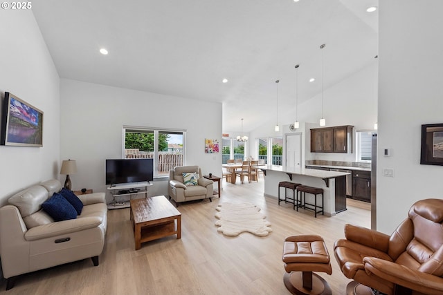 822 Spyglass Dr, Bandon, OR 97411 - living area with light wood finished floors, recessed lighting, a chandelier, and high vaulted ceiling