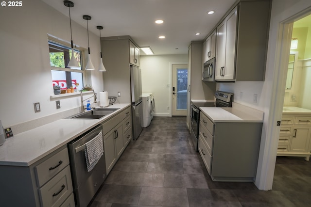 kitchen with washer and clothes dryer, light countertops, recessed lighting, stainless steel appliances, and a sink