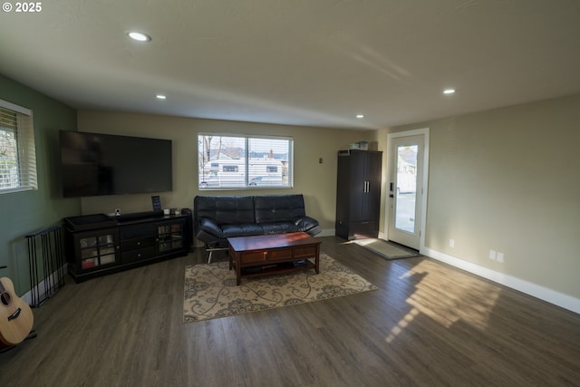 living area with recessed lighting, plenty of natural light, wood finished floors, and baseboards