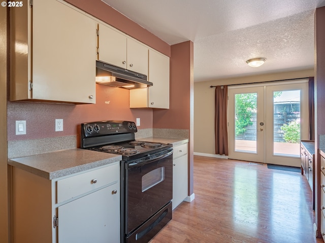 841 NE Kathryn St, Hillsboro, OR 97124 - kitchen with black range with electric cooktop, under cabinet range hood, light wood-style flooring, light countertops, and a textured ceiling
