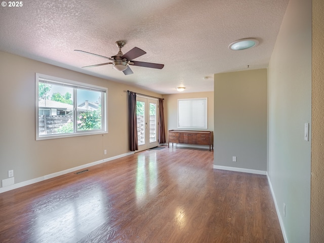 841 NE Kathryn St, Hillsboro, OR 97124 - empty room featuring a textured ceiling, wood finished floors, ceiling fan, and baseboards