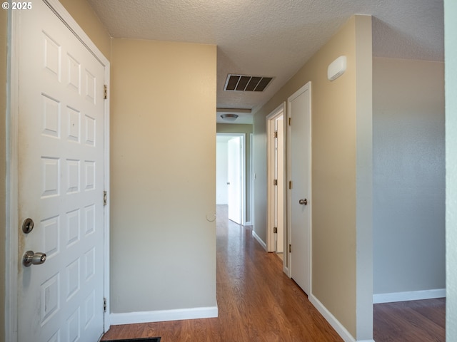 841 NE Kathryn St, Hillsboro, OR 97124 - hall featuring wood finished floors, a textured ceiling, and baseboards
