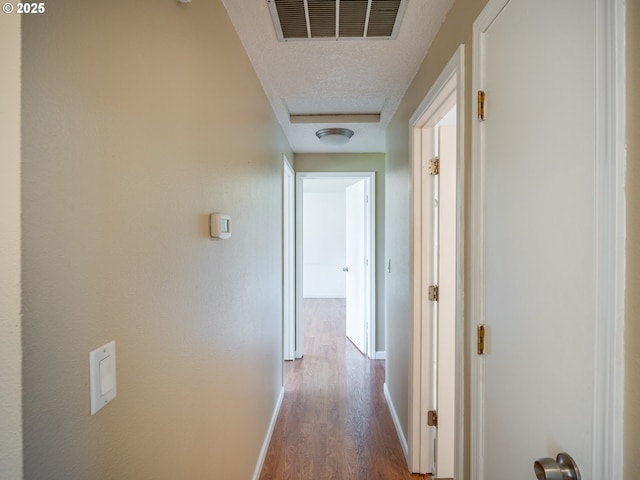 841 NE Kathryn St, Hillsboro, OR 97124 - corridor featuring wood finished floors, a textured ceiling, and baseboards