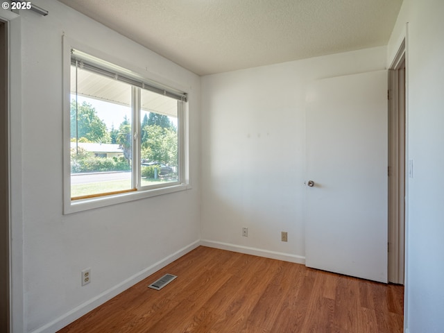 841 NE Kathryn St, Hillsboro, OR 97124 - unfurnished room featuring wood finished floors, baseboards, and a textured ceiling