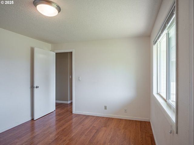 841 NE Kathryn St, Hillsboro, OR 97124 - spare room featuring wood finished floors, a textured ceiling, and baseboards