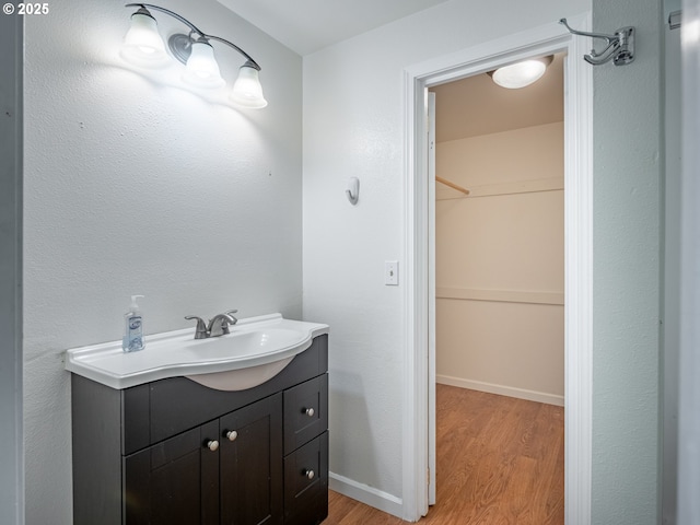 841 NE Kathryn St, Hillsboro, OR 97124 - bathroom featuring wood finished floors, vanity, and baseboards