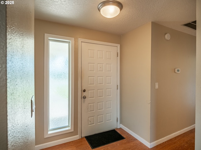 841 NE Kathryn St, Hillsboro, OR 97124 - foyer with wood finished floors, a textured ceiling, and baseboards