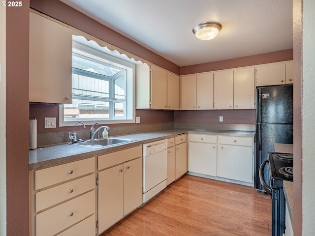 841 NE Kathryn St, Hillsboro, OR 97124 - kitchen with dishwasher, black range with electric stovetop, a sink, and light wood-style floors