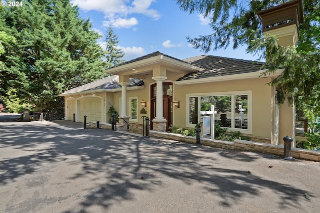 prairie-style home featuring a garage