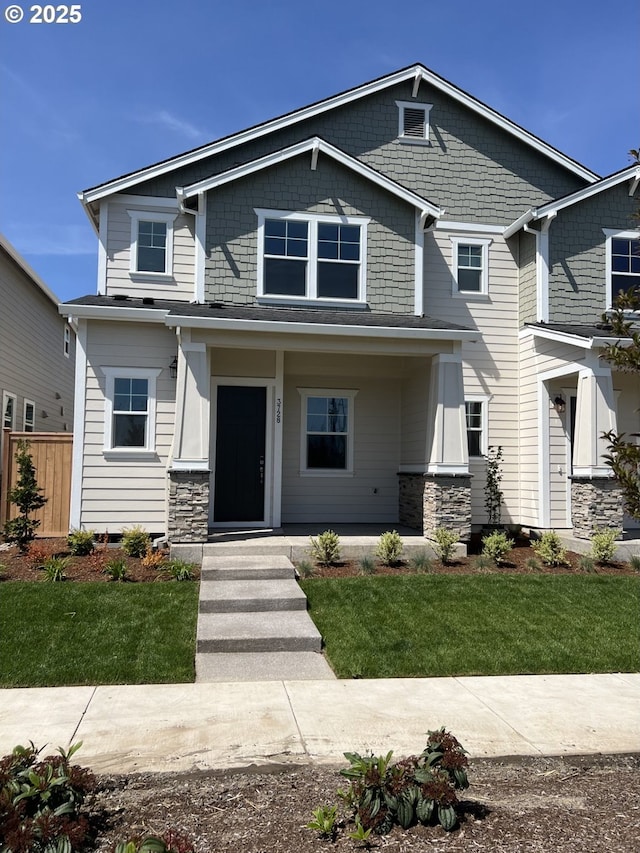 craftsman-style house featuring a porch and a front lawn