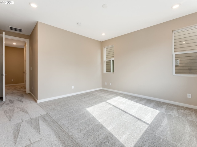spare room with carpet, recessed lighting, and baseboards