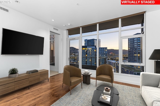949 NW Overton St Unit 1304, Portland, OR 97209 - living area featuring a city view, wood finished floors, and recessed lighting