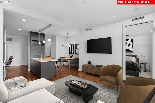 949 NW Overton St Unit 1304, Portland, OR 97209 - living area featuring dark wood-style flooring, recessed lighting, attic access, and baseboards