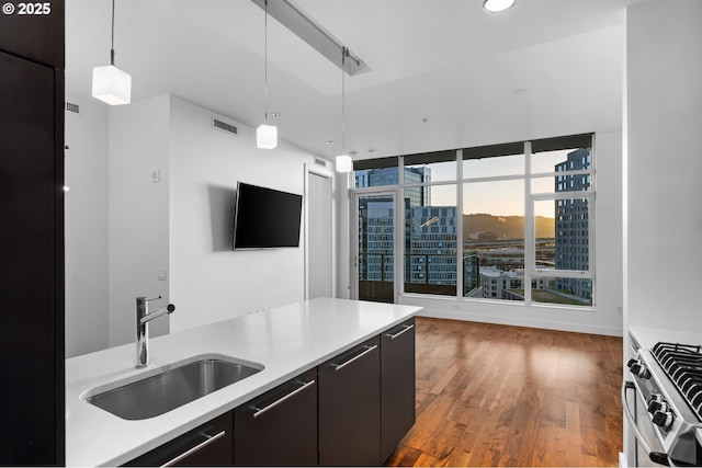 949 NW Overton St Unit 1304, Portland, OR 97209 - kitchen featuring a sink, hanging light fixtures, wood finished floors, gas stove, and recessed lighting