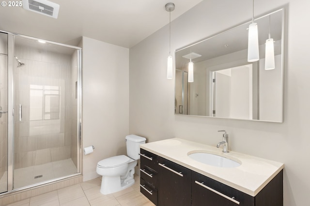 949 NW Overton St Unit 1304, Portland, OR 97209 - full bathroom featuring toilet, vanity, a shower stall, and tile patterned floors