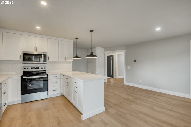 kitchen with appliances with stainless steel finishes, white cabinetry, backsplash, hanging light fixtures, and kitchen peninsula