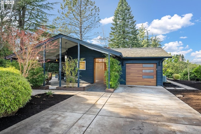 view of front of house with central air condition unit and a garage