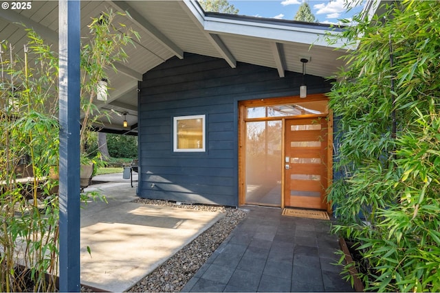 view of exterior entry with a patio