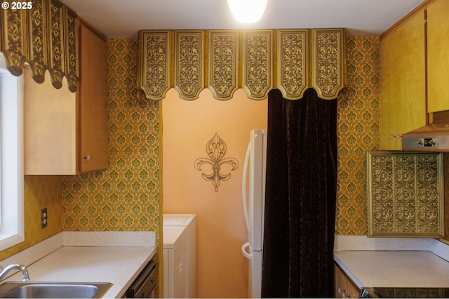 washroom with washer / dryer and a sink