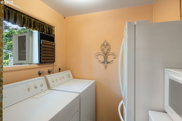 laundry area with washing machine and clothes dryer and cooling unit