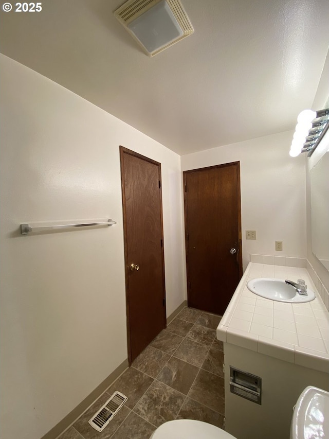 845 Waite St, Eugene, OR 97402 - half bathroom featuring toilet, vanity, and baseboards