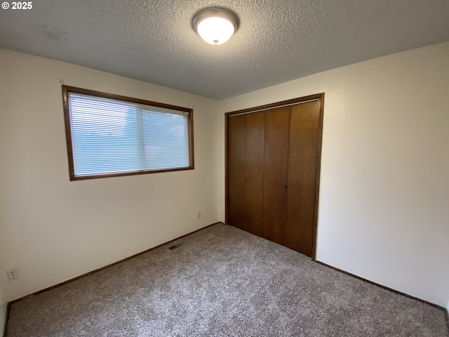 845 Waite St, Eugene, OR 97402 - unfurnished bedroom with a closet, carpet flooring, and a textured ceiling