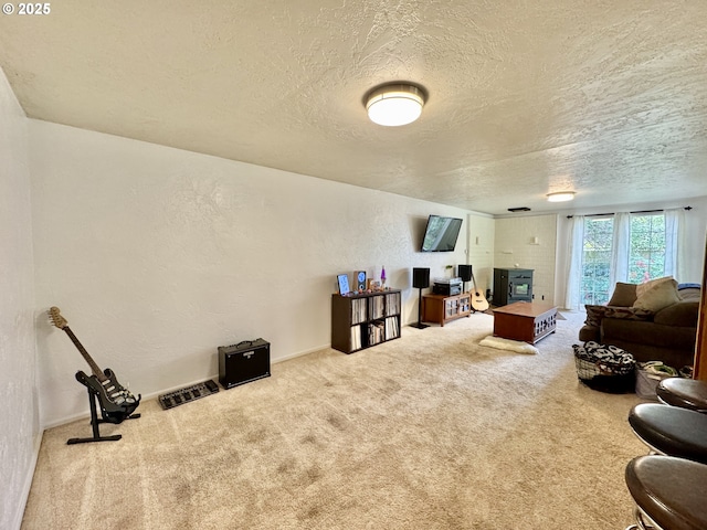 carpeted living room featuring a textured wall and a textured ceiling