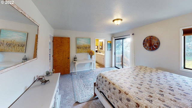 bedroom featuring light carpet and connected bathroom