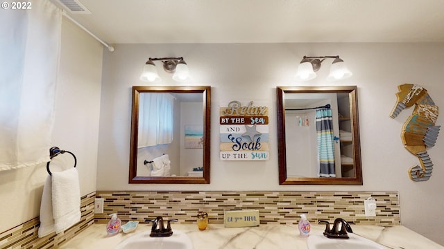 bathroom with backsplash and vanity