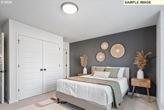 bedroom with light carpet and a closet