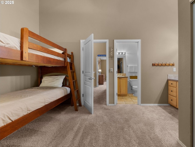 30605 E Camryn Way Unit D20, Government Camp, OR 97028 - bedroom with light carpet, baseboards, ensuite bathroom, and a towering ceiling