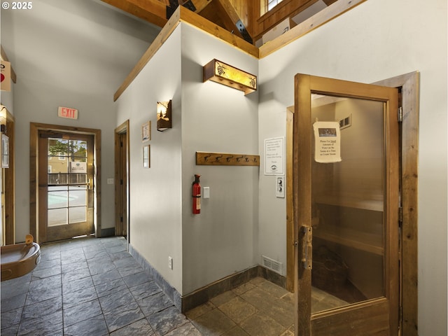30605 E Camryn Way Unit D20, Government Camp, OR 97028 - hallway featuring stone tile floors, baseboards, a high ceiling, and a relaxing sauna