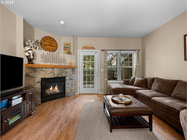 30605 E Camryn Way Unit D20, Government Camp, OR 97028 - living room featuring a stone fireplace and wood finished floors