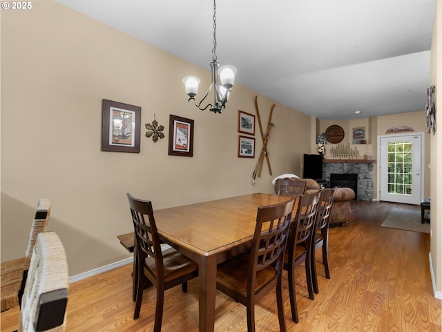 30605 E Camryn Way Unit D20, Government Camp, OR 97028 - dining room with light wood finished floors, a fireplace, a chandelier, and baseboards
