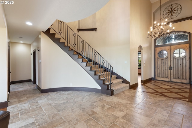 632 W T St, Washougal, WA 98671 - entryway with stone tile flooring, baseboards, a chandelier, arched walkways, and stairs
