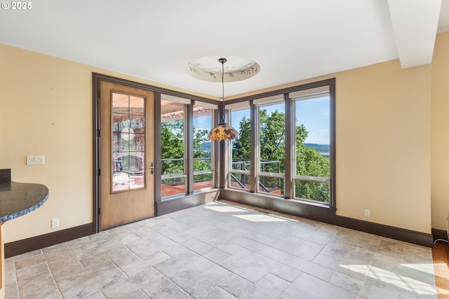 632 W T St, Washougal, WA 98671 - unfurnished dining area with baseboards, healthy amount of natural light, and stone finish flooring