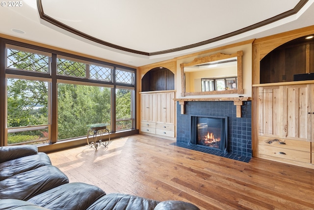 632 W T St, Washougal, WA 98671 - living room with a tray ceiling, ornamental molding, wood-type flooring, and a tile fireplace