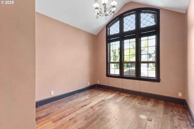 632 W T St, Washougal, WA 98671 - spare room featuring a chandelier, hardwood / wood-style flooring, vaulted ceiling, and baseboards
