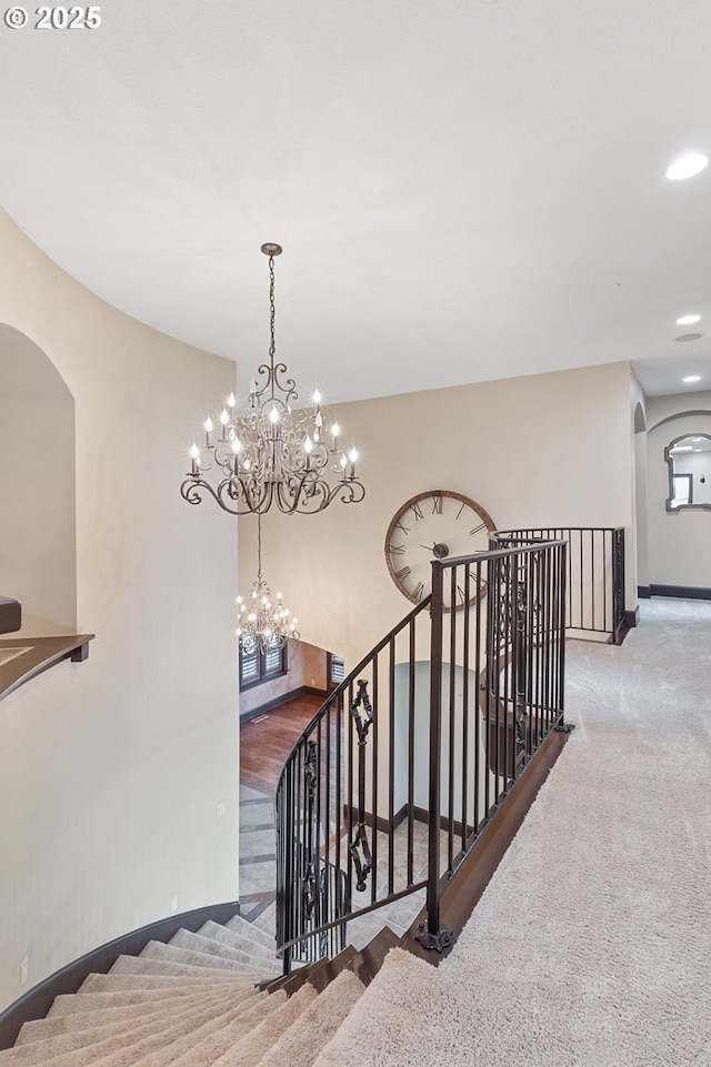 632 W T St, Washougal, WA 98671 - staircase with arched walkways, a chandelier, baseboards, carpet, and recessed lighting