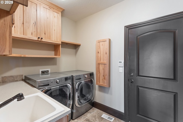 632 W T St, Washougal, WA 98671 - laundry area with cabinet space, separate washer and dryer, baseboards, and a textured ceiling