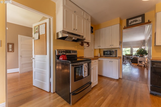 kitchen featuring light wood finished floors, under cabinet range hood, white cabinets, and stainless steel appliances