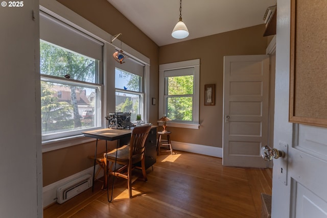 office area with baseboards, hardwood / wood-style flooring, and a baseboard radiator