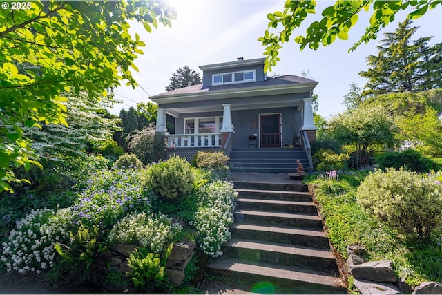 bungalow-style house with covered porch and stairway