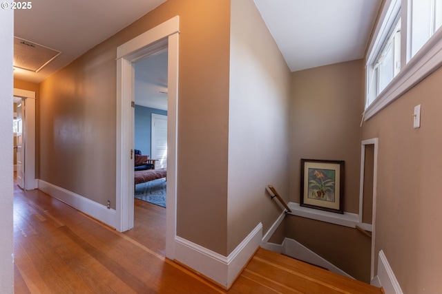 stairs with baseboards and wood finished floors