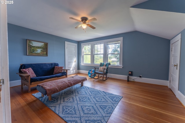 living room with baseboards, a ceiling fan, wood finished floors, and lofted ceiling