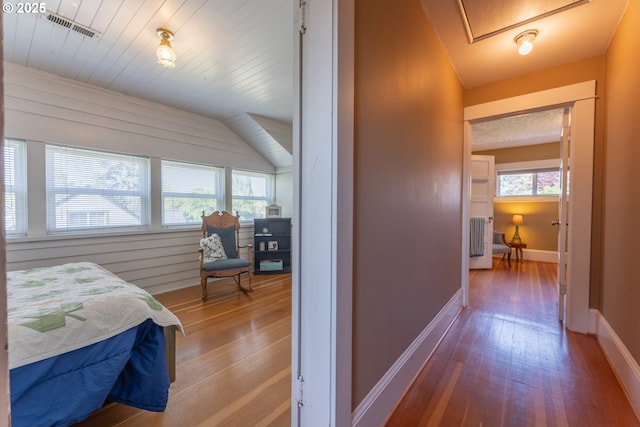 bedroom featuring wooden ceiling, baseboards, wood-type flooring, and visible vents