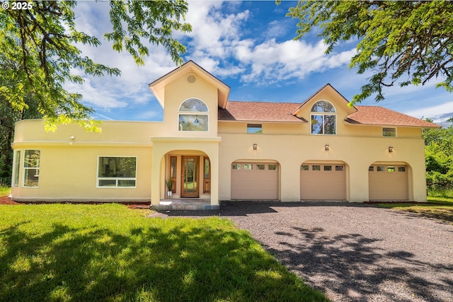 28788 Gimpl Hill Rd, Eugene, OR 97402 - mediterranean / spanish-style home featuring driveway, an attached garage, a front lawn, and stucco siding