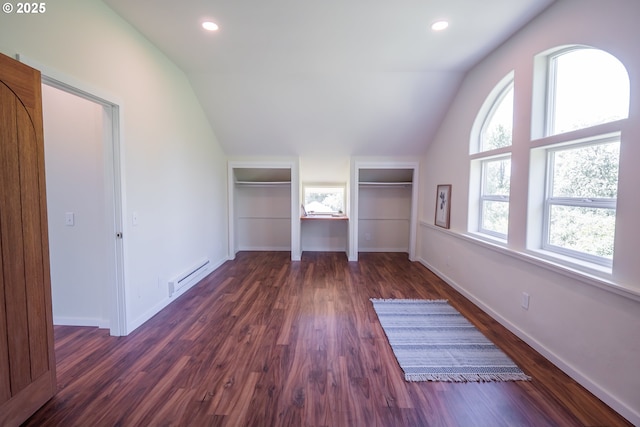 28788 Gimpl Hill Rd, Eugene, OR 97402 - unfurnished bedroom with vaulted ceiling, a baseboard radiator, dark wood-style flooring, multiple closets, and baseboards