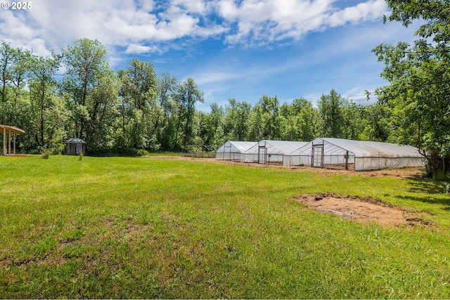 28788 Gimpl Hill Rd, Eugene, OR 97402 - view of green lawn with an exterior structure, an outdoor structure, and a wooded view