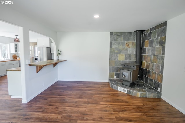 28788 Gimpl Hill Rd, Eugene, OR 97402 - unfurnished living room with a sink, dark wood finished floors, baseboards, recessed lighting, and a wood stove